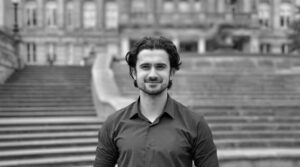 Profile photo of Fahad Zia in front of staircase of a university building